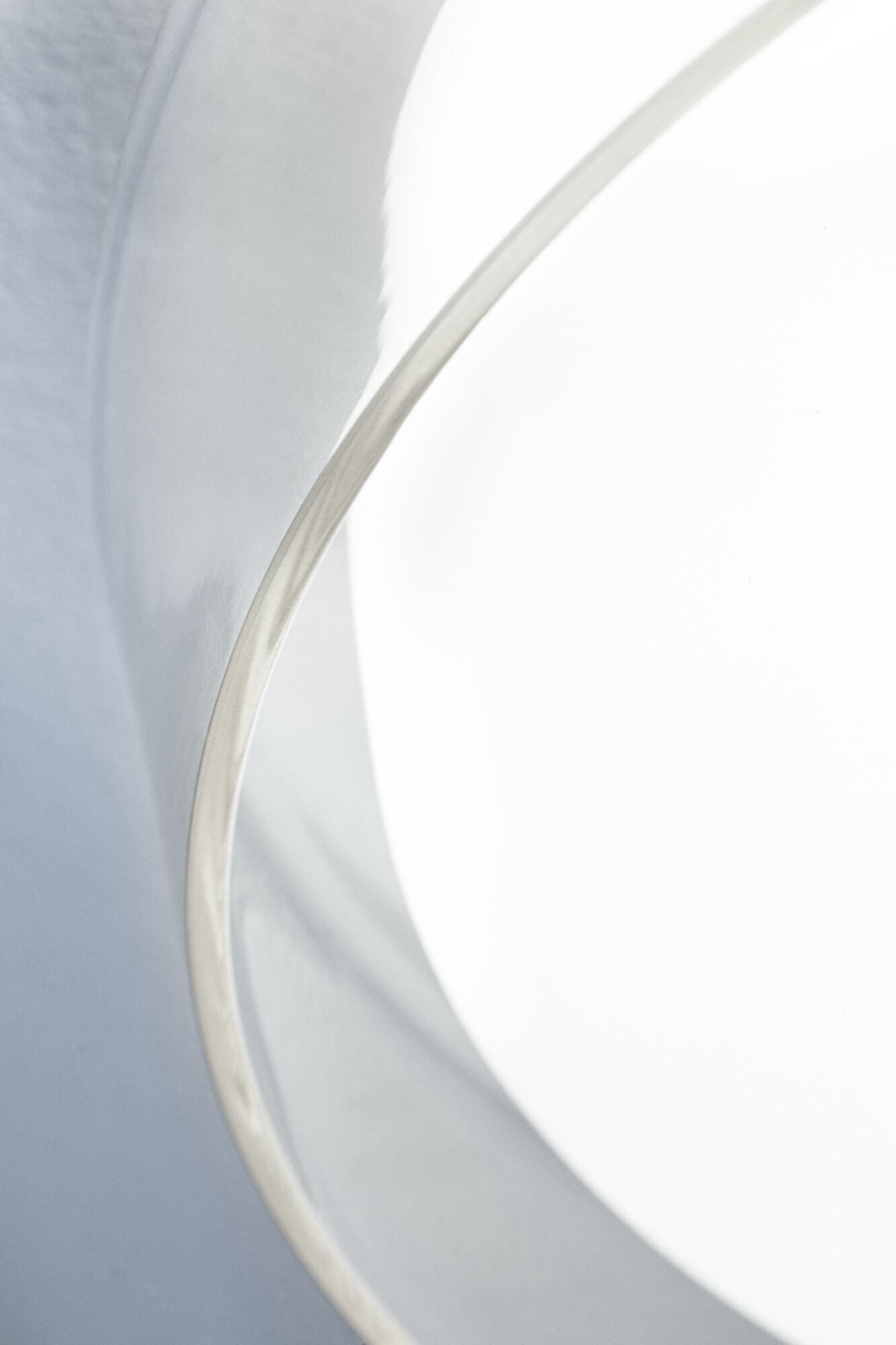 Close-up of white lampshade with silver metal edge for modern LED lighting design