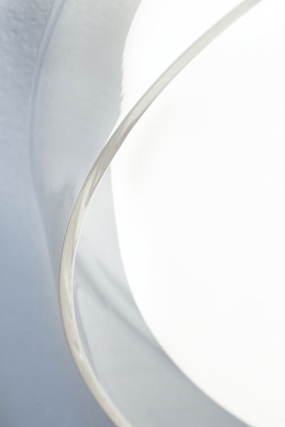 Close-up of white lampshade with silver metal edge for modern LED lighting design