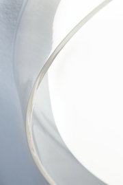 Close-up of white lampshade with silver metal edge for modern LED lighting design