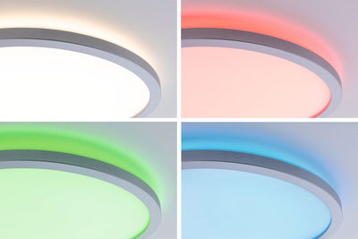 Round LED ceiling light with silver frame showing white, red, green, and blue colors for home lighting