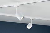 Two white metal LED spotlights on track system mounted on white ceiling for modern lighting