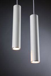 Two white cylindrical metal LED pendant lights with warm light for modern interior lighting