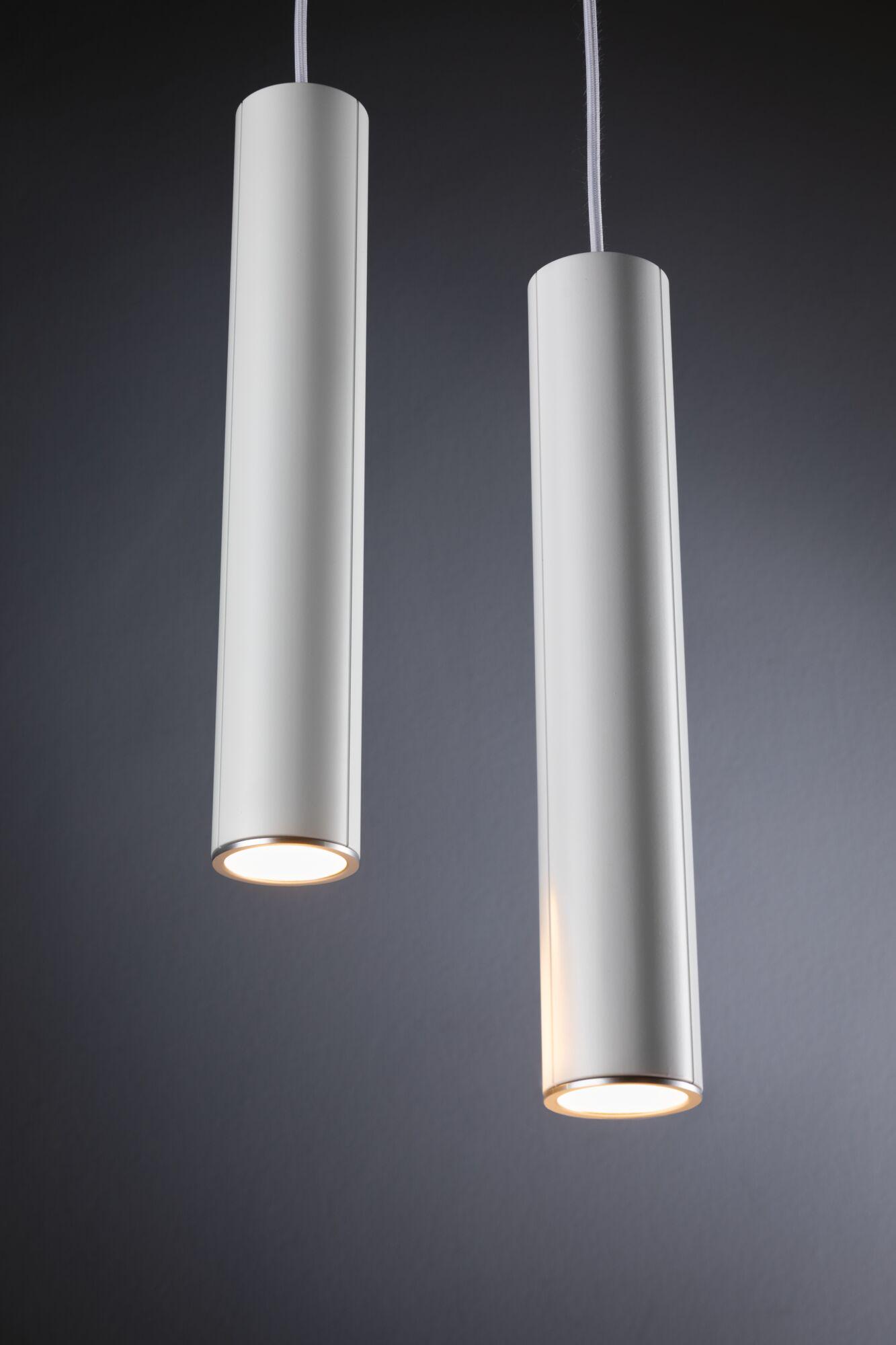 Two white cylindrical metal LED pendant lights with warm light for modern interior lighting