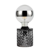 Light bulb with silver mirror cap and clear glass base on black textured holder for lighting decor