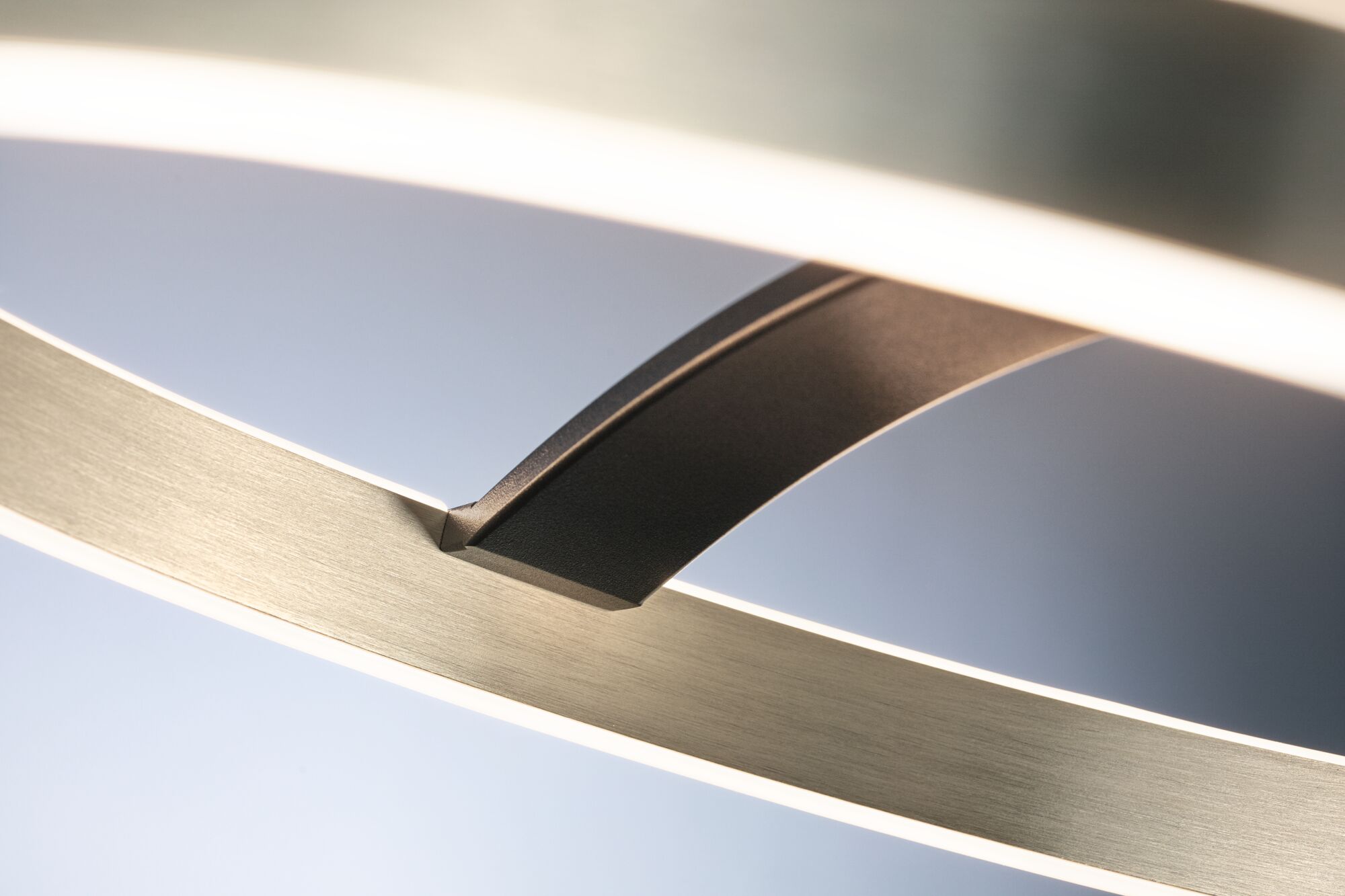 Close-up of modern LED ceiling light in brushed aluminium with black connector detail