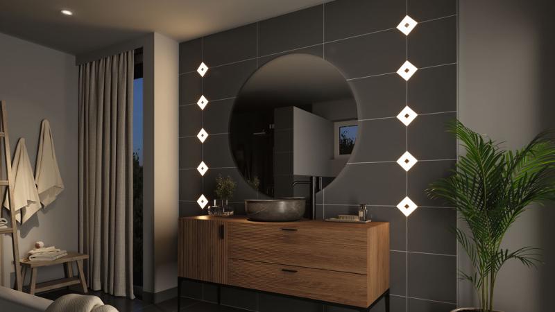 Moderne badkamer met houten wastafelmeubel, ronde spiegel en witte vierkante LED-wandlampen.