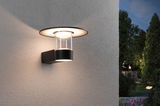 Modern black outdoor wall light with glass cylinder and warm white LED for garden lighting