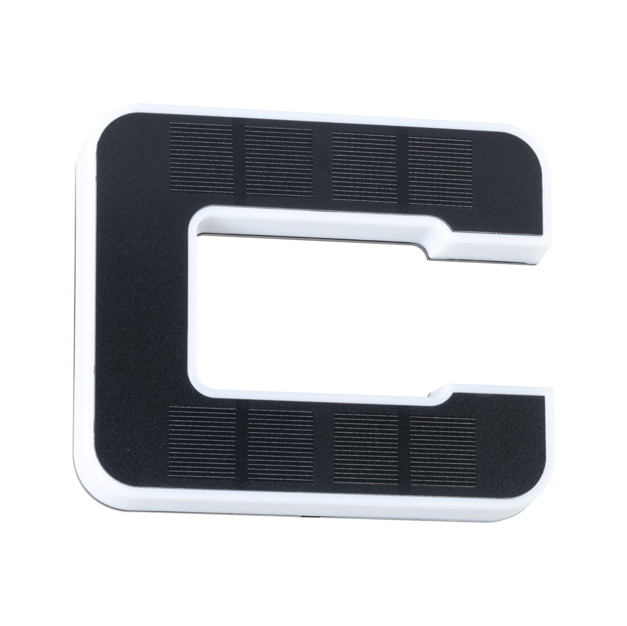 White plastic holder with black non-slip surface and cutout for cable management