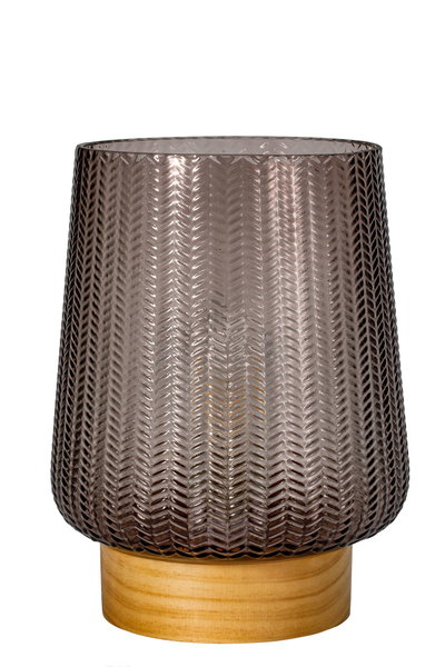 Patterned smoky grey glass candle holder on light wooden base, decorative home accessory