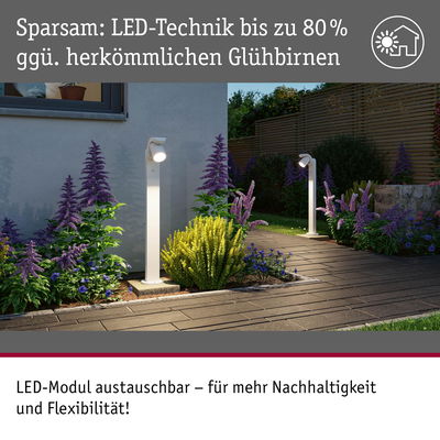 Weiße LED-Außenleuchten mit austauschbarem Modul beleuchten Gartenweg mit lila und gelben Pflanzen