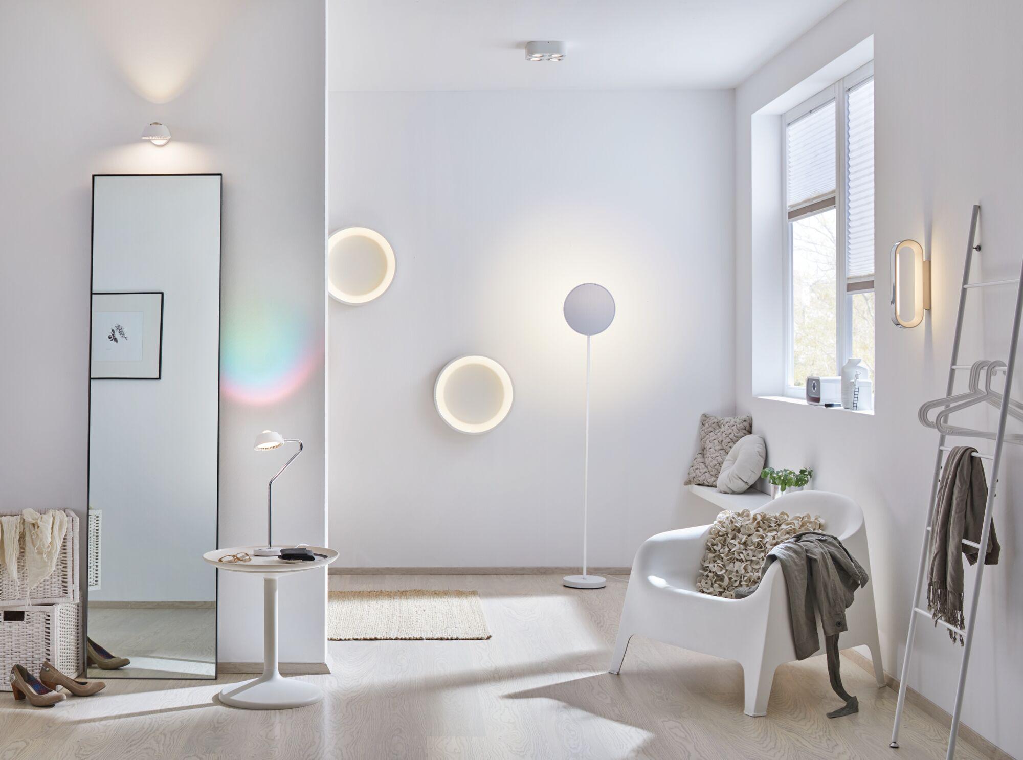 Modern living room with white walls, round LED wall lights, and minimalist design for ambient home lighting