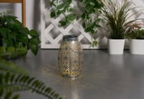 Metal lantern with intricate pattern and warm light, decorative for garden or patio lighting