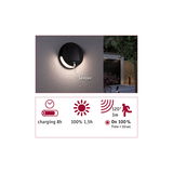 Round black solar wall light with sensor and LED for outdoor use, energy-saving garden lighting solution