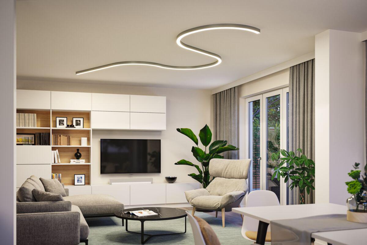 Modern living room with curved white LED ceiling light for stylish ambient lighting.