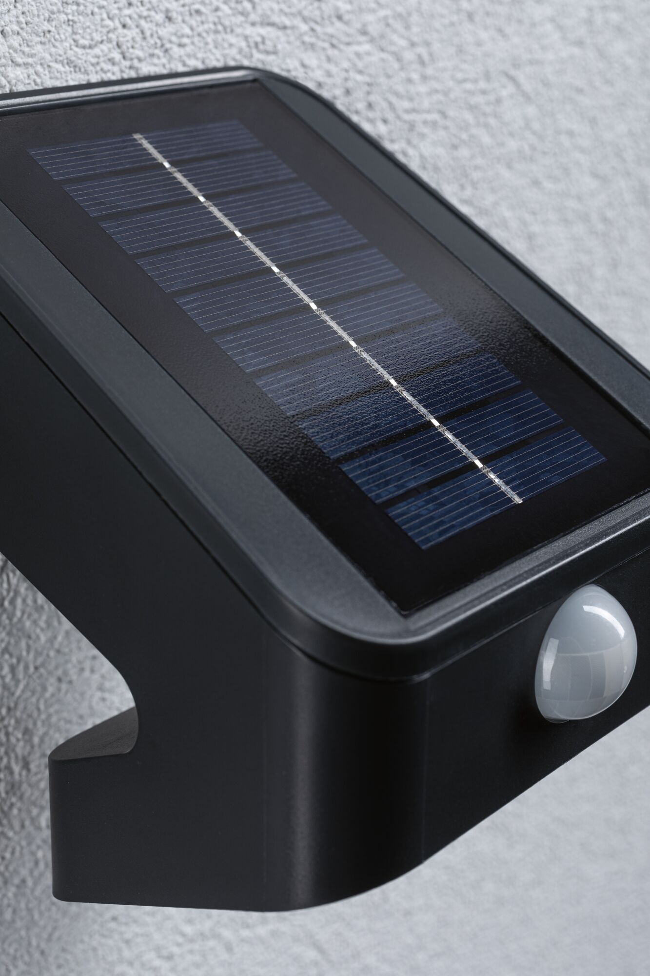 Black solar light with motion sensor and solar panel for energy-efficient outdoor lighting