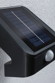 Black solar light with motion sensor and solar panel for energy-efficient outdoor lighting