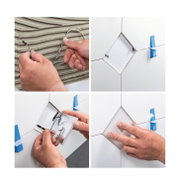 Installation of white ceramic LED tile with cable connection on wall tiles using spacers.