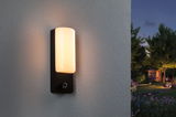Modern black outdoor wall light with warm white glow and motion sensor for garden lighting.