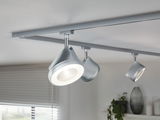 Moderne Deckenstrahler aus silbernem Metall mit LED-Beleuchtung an Schienensystem für Wohnräume