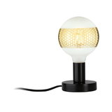 Modern table lamp with black metal base and white-gold glass globe shade for stylish home lighting
