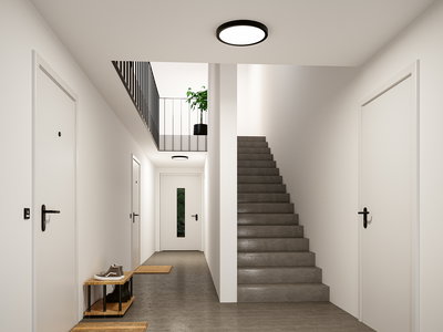 Rundes LED-Deckenlicht in Schwarz-Weiß in modernem Treppenhaus mit Betonboden und weißen Türen