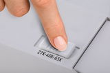 Finger adjusting white slider switch labeled 27K-40K-65K on grey plastic device surface