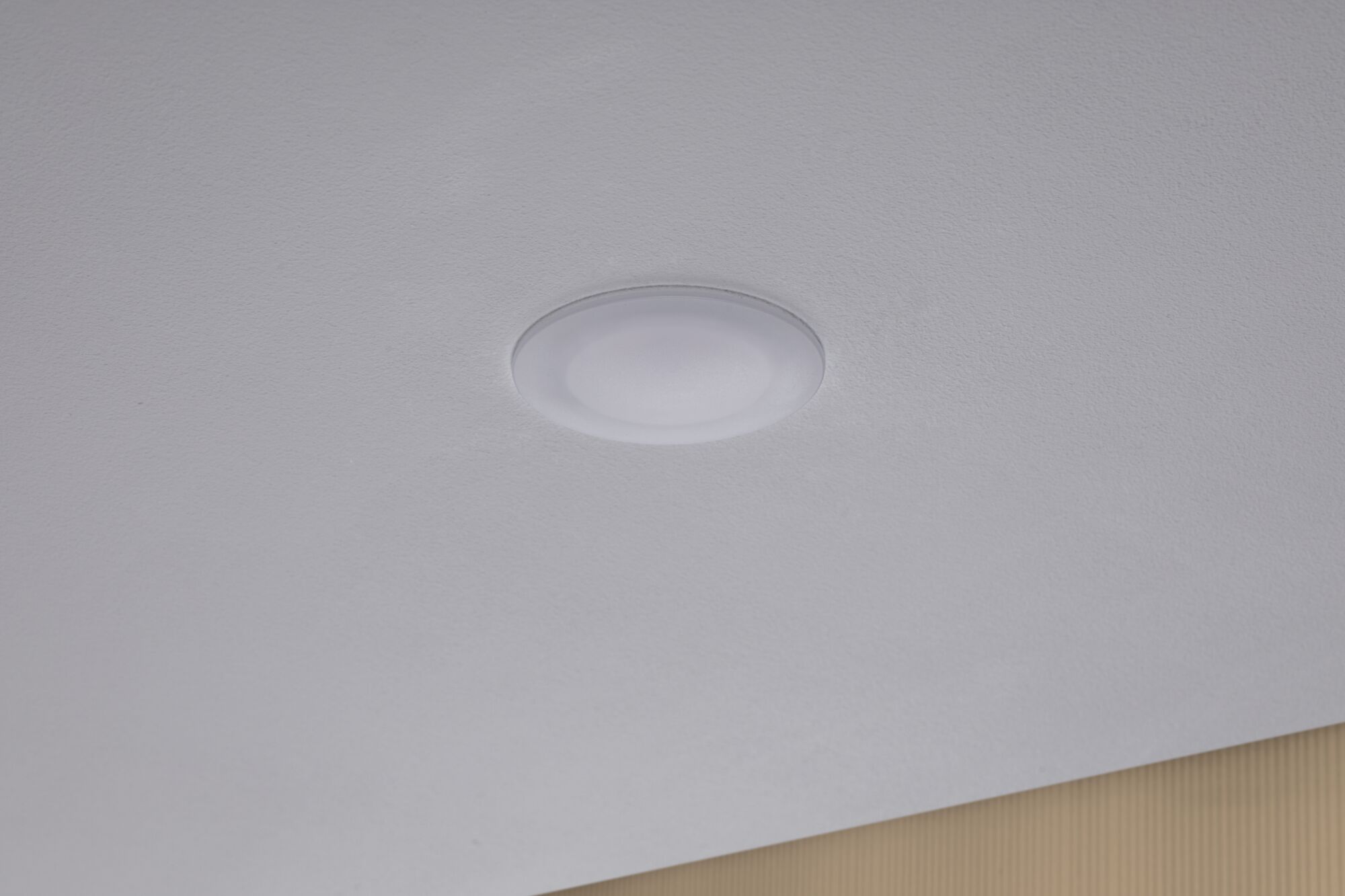 Round white LED ceiling light made of plastic, minimalist design for modern interiors.