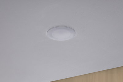 Round white LED ceiling light made of plastic, minimalist design for modern interiors.