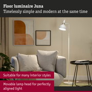 White metal floor lamp Juna with adjustable head beside grey sofa and abstract wall art in living room