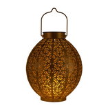 Round brown metal lantern with intricate floral patterns and warm light for atmospheric lighting