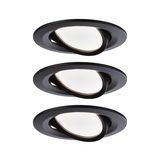 Three black recessed spotlights with white light and adjustable tilt for modern indoor lighting