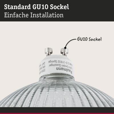 Nahaufnahme einer GU10 Fassung mit weißem Sockel und geriffeltem Glas für LED-Lampen