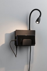 Black wall lamp with flexible reading arm and metal smartphone holder for modern charging and lighting