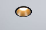 Round recessed light with black frame and gold reflector for modern LED lighting solutions