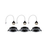 Three black recessed spotlights with white cable connectors for LED lighting installation