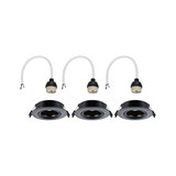 Three black recessed spotlights with white cable connectors for LED lighting installation