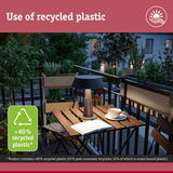 Modern table lamp made from over 60% recycled plastic on balcony with wooden table and plants