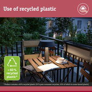 Modern outdoor balcony with lamp made from over 60% recycled plastic on wooden table