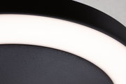 Close-up of black LED ceiling light with white glowing ring made of metal and plastic