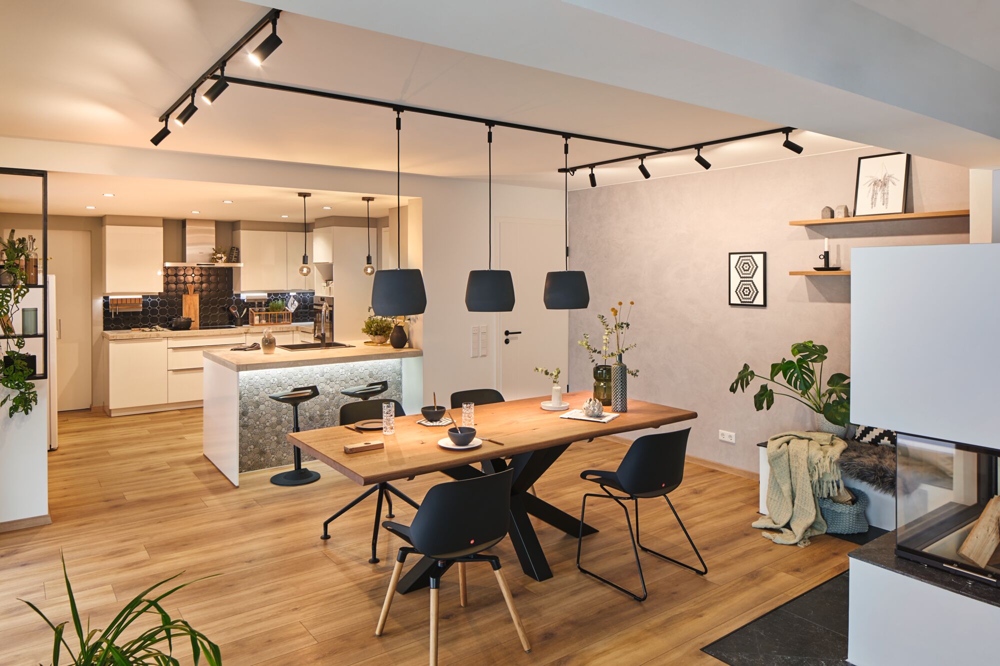 Modern dining room with wooden table, black chairs, pendant lights, stylish home lighting design.