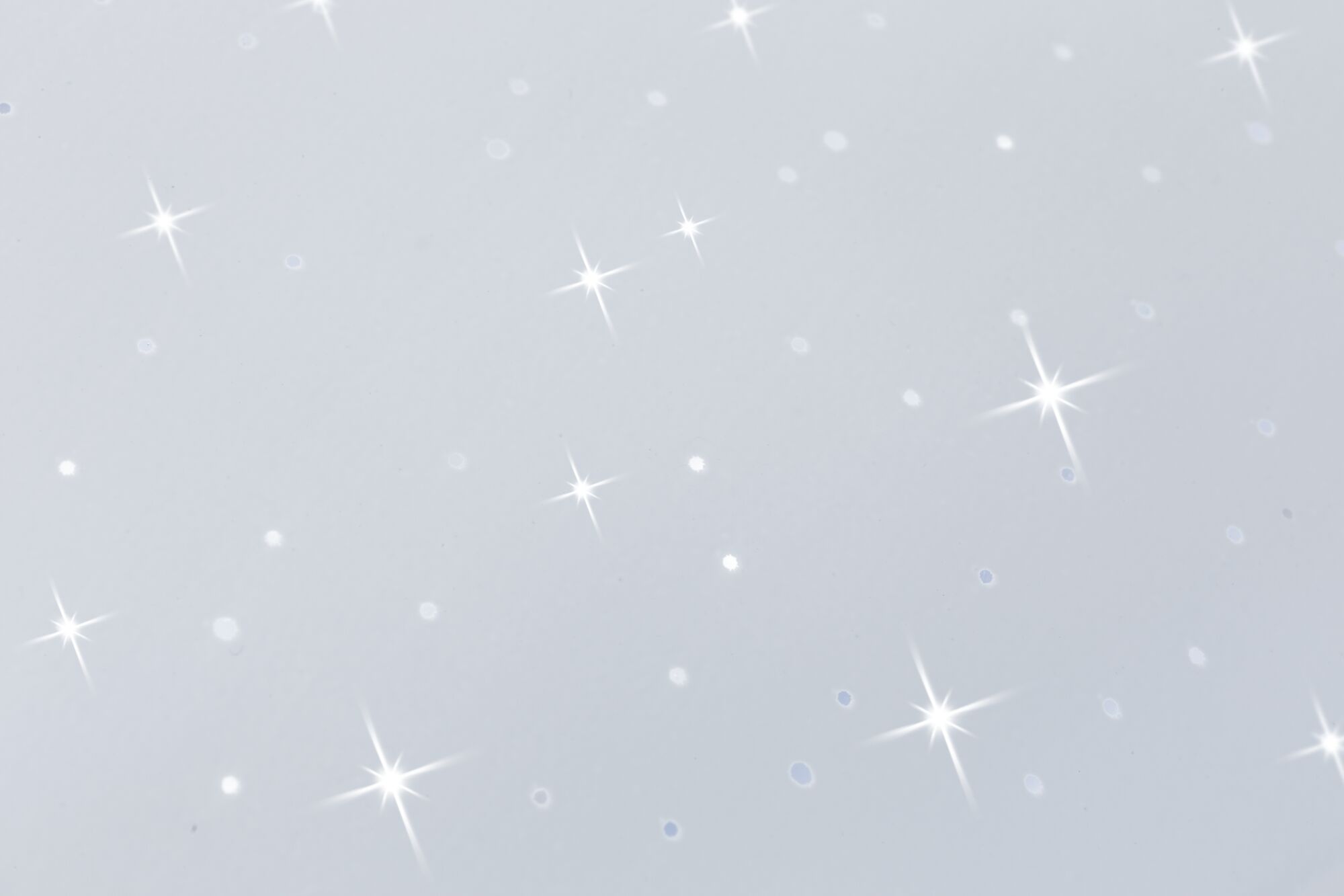 White surface with sparkling light reflections and glittering star effects for decoration and lighting
