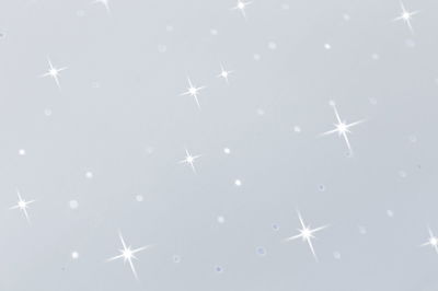 White surface with sparkling light reflections and glittering star effects for decoration and lighting