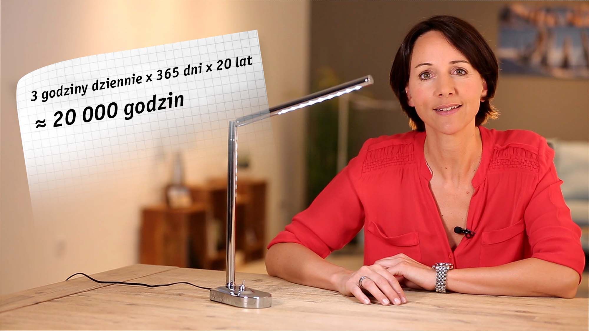 Modern silver LED desk lamp on wooden table beside woman in red shirt, lighting concept illustration