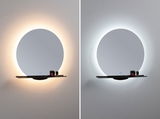 Round wall mirror with black shelf and warm white and cool white LED backlighting for bathroom