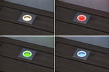 Vier vierkante witte LED-vloerinbouwspots met wisselende kleuren rood, groen, blauw en warm wit.