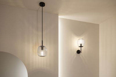 Modern pendant and wall light with ribbed glass and black metal for stylish indoor lighting