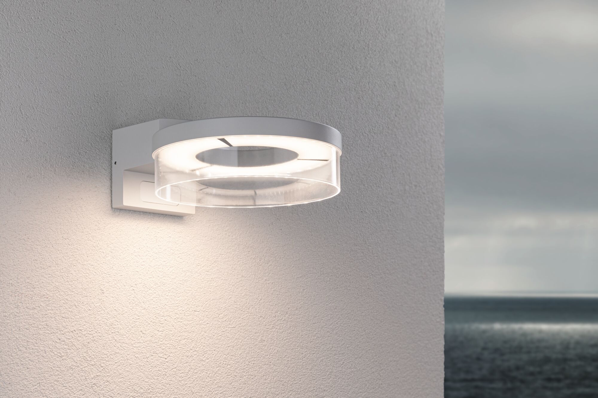 Modern white LED wall light with transparent diffuser for outdoor and garden lighting