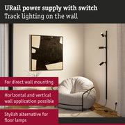 Black URail power supply with switch mounted on wall, modern LED spotlights for living room lighting