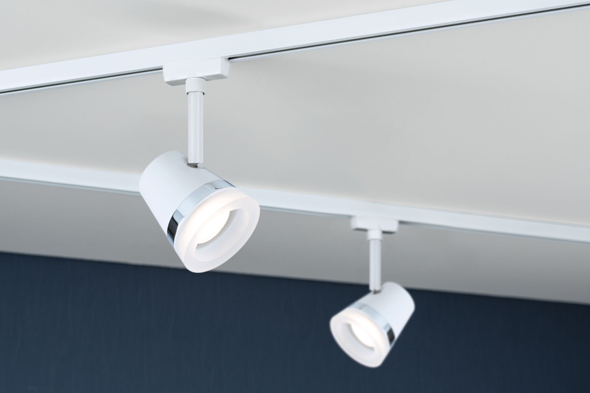 Two white LED track spotlights with chrome ring mounted on ceiling for modern room lighting