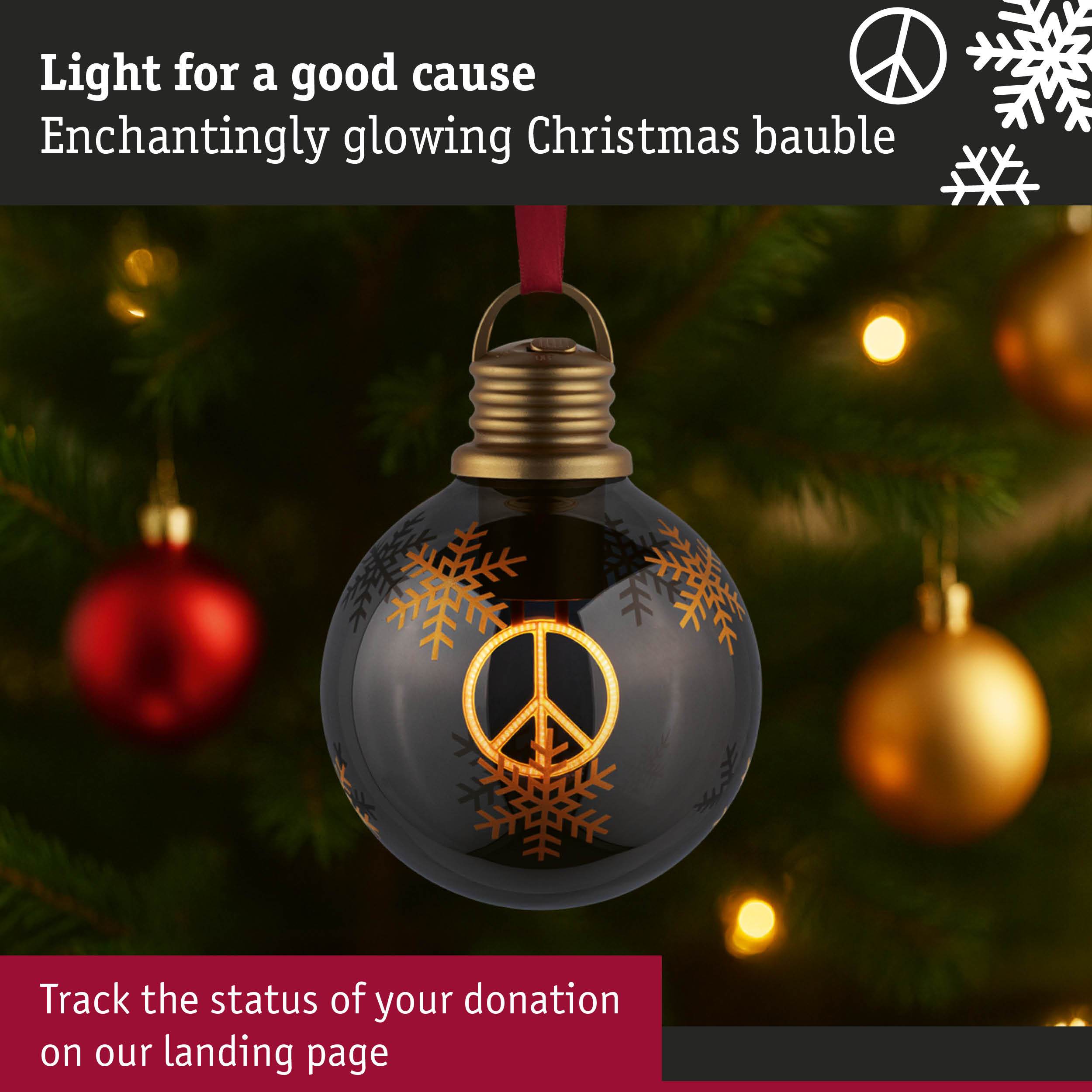 Black Christmas bauble with golden peace sign and snowflakes, glowing on a decorated tree